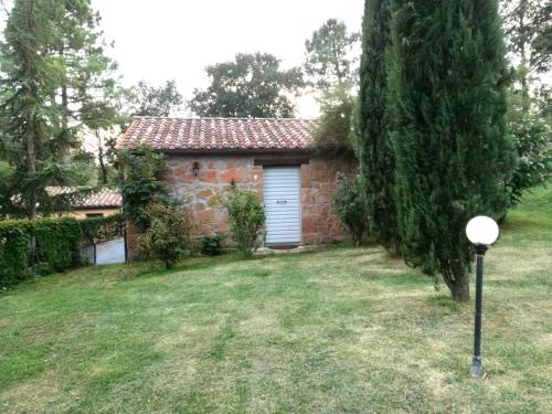 a brick house with a garage in a yard at Il Sentiero in Acquapendente