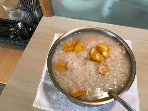 a bowl of rice with fruit on a table at Goose House in Yung-an-ts'un