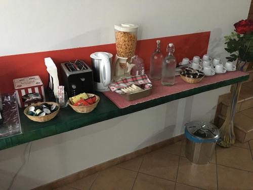 a counter with cups and other items on it at Il Trattore in Moncalieri