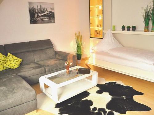 a living room with a couch and a coffee table at Ferienhaus Jäger in Friedrichshafen