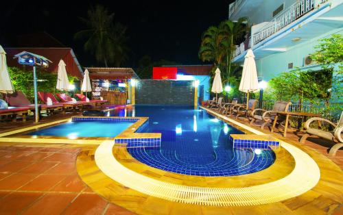 a swimming pool at a resort at night at Blossoming Romduol Boutique in Siem Reap