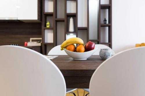 a bowl of fruit sitting on a wooden table at Turistic Apartments Centar Sarajevo in Sarajevo