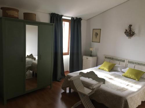 a bedroom with a large bed and a mirror at Affittacamere Arco Polinori in Foligno