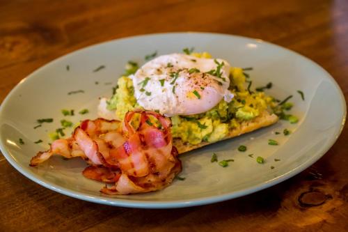 a plate of food with shrimp and eggs on a table at Old Town Boutique Hotel in Bucharest