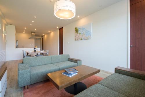 a living room with a couch and a table at Niseko Landmark View in Kutchan