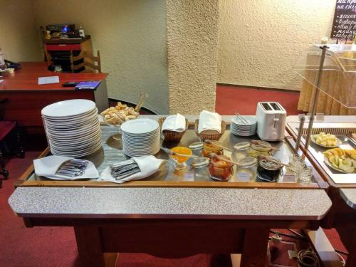 a table with plates and bowls of food on it at Salute Hotel in Kyiv