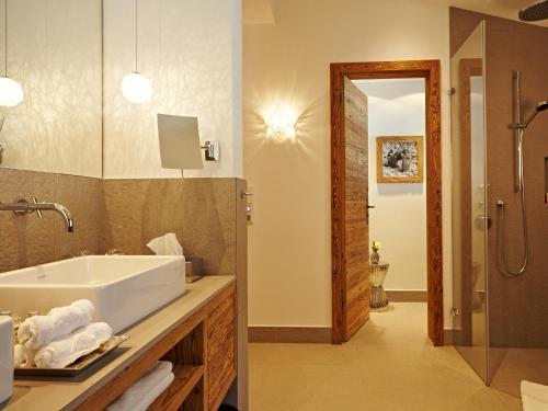 a bathroom with a sink and a shower at Chalet-F in Ofterschwang