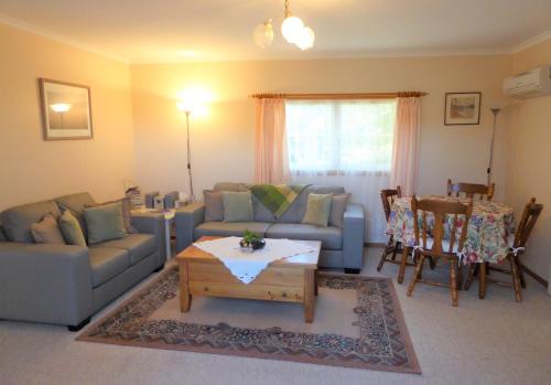 a living room with a couch and a coffee table at Tamar River Retreat in Kayena