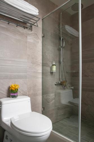 a bathroom with a toilet and a glass shower at Beauty Hotels Taipei - Hotel B7 in Taipei