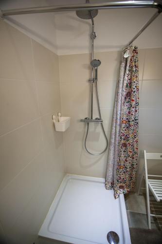 a shower in a bathroom with a shower curtain at Holiday Home Kuca na Moru in Kornić