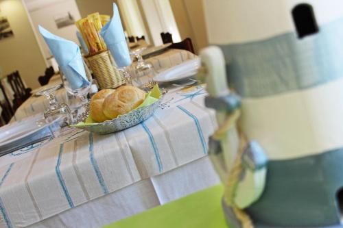 a table with a bowl of bread on it at Hotel Silvia in Misano Adriatico