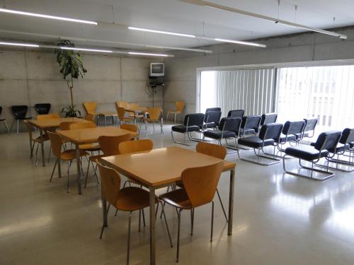 duży pokój ze stołami i krzesłami w obiekcie Residència Universitària Sant Joan w mieście Reus