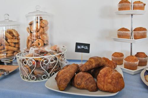 a table with various types of pastries and muffins at Hotel Touring in Misano Adriatico
