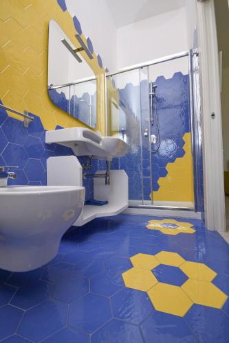 a bathroom with a toilet and a sink and a shower at Merydamy in Mattinata