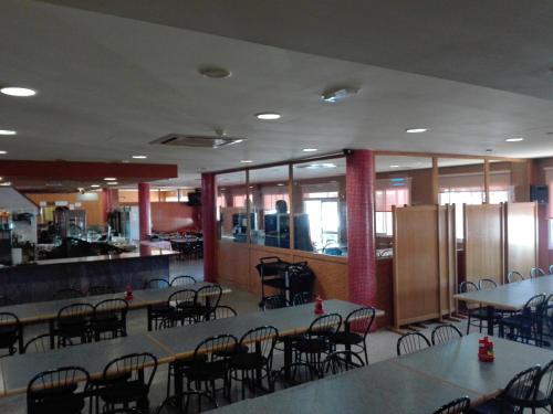 a room with tables and chairs and a cafeteria at Hotel Restaurant Casa Miquel in Alcarraz