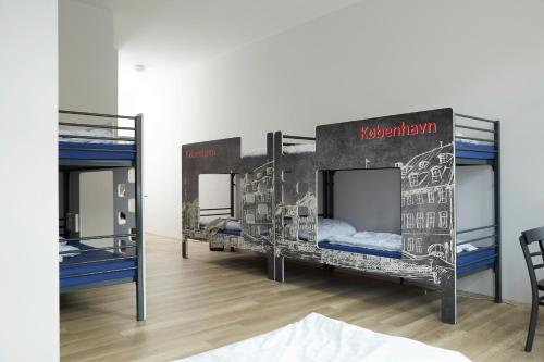 a room with three bunk beds in it at a&o Copenhagen Nørrebro in Copenhagen