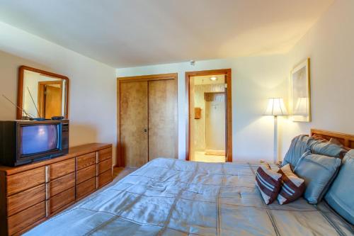 a bedroom with a blue bed and a television at Lakeview Marina Place in Dillon