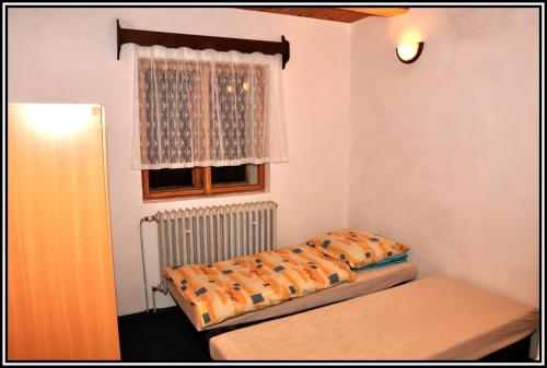 a bedroom with two beds and a window at Ubytování Petrovičky in Mladkov