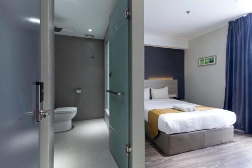 八打灵再也Hotel 99 Kelana Jaya (PJ)的酒店客房设有一张床和一个卫生间。