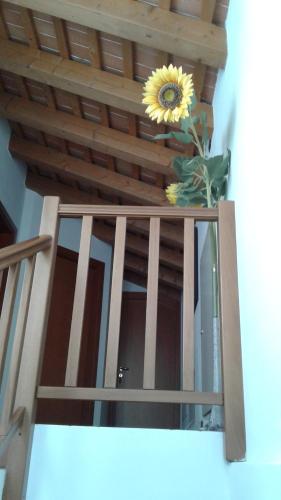 a vase with a sunflower on top of a balcony at b&b Ergira in Cividale del Friuli