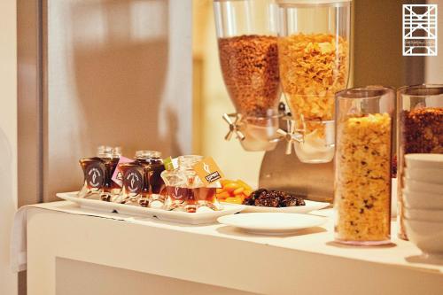 a counter with a table with food and a mirror at Le Pinarello in Sainte-Lucie de Porto-Vecchio