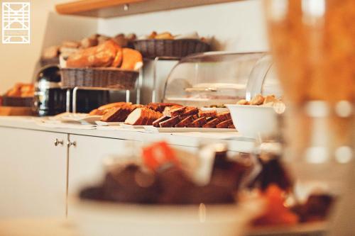a buffet filled with lots of different types of food at Le Pinarello in Sainte-Lucie de Porto-Vecchio