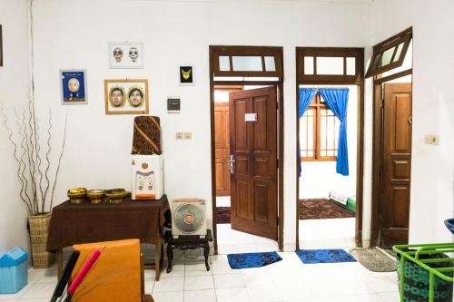 a living room with a table and a door at Glory Homestay in Yogyakarta