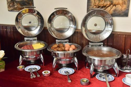 a group of metal food pans on a table at San Giovanni Stanly Hotel in Alexandria
