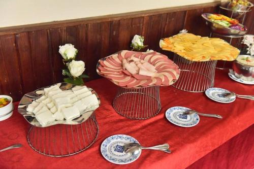 a table with three plates of food on a red table at San Giovanni Stanly Hotel in Alexandria