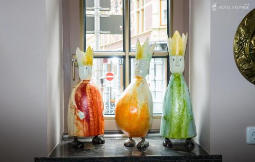a group of three glass vases sitting on a window sill at Hotel 3 Könige in Aachen