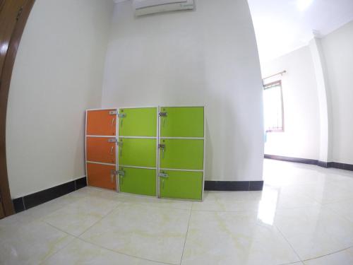 a green and orange cabinet in a room at Blue Diamond Hostel in Battambang