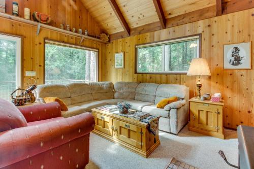 a living room with a couch and a table at The Chalet on Lopez in Islandale