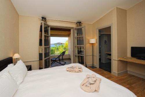 a hotel room with a bed with towels on it at Le Pinarello in Sainte-Lucie de Porto-Vecchio
