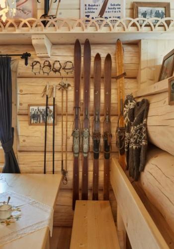 a bunch of skis are hanging on a wall at Hotel Gazdówka Spa in Osielsko