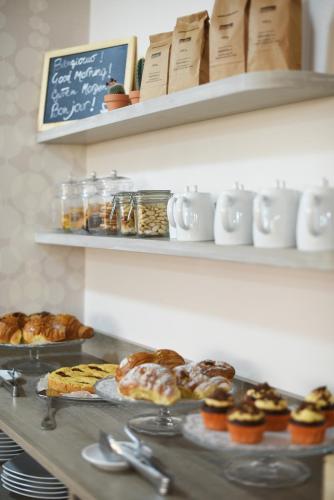 a table with pastries and other pastries on at Ulivi Hotel & Residence in Paratico