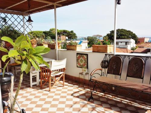 a patio with a table and chairs on a roof at Casa Lunastella Locazione Turistica in Mondello