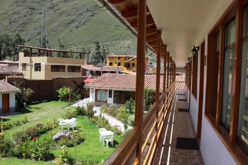 a balcony of a house with a view of a yard at Hotel Tierra Inka Sacred Valley in Ollantaytambo