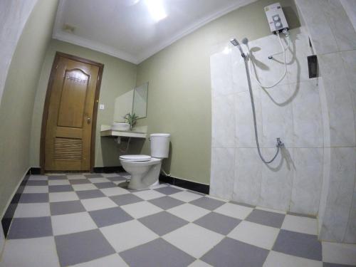 a bathroom with a toilet and a shower in it at Blue Diamond Hostel in Battambang