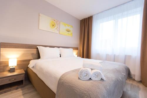 a hotel room with a bed with towels on it at Montana Studios in Braşov