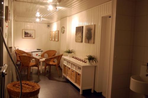 a dining room with a table and a table and chairs at Stora Hotellet Markaryd in Markaryd