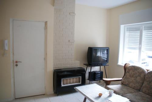 a living room with a couch and a tv at Appartements Brussel in Brussels