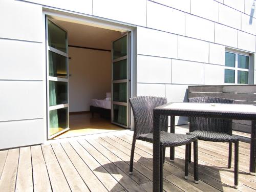 a patio with a table and chairs in front of a building at Al Marinaio Hotel Garni in Trento