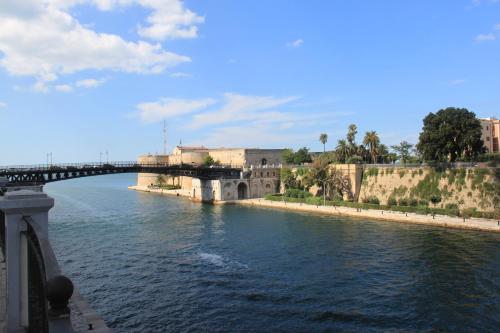 a bridge over a river next to a city at Hotel Plaza in Taranto