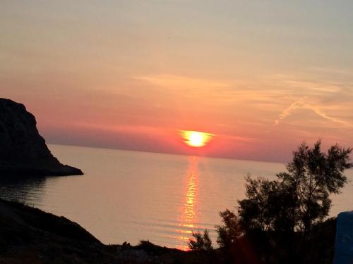 a sunset over a body of water at Seaside Studios Arkasa Karpathos in Arkasa