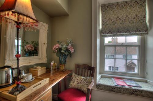 a kitchen with a window and a window sill at Dunster Castle Hotel in Dunster