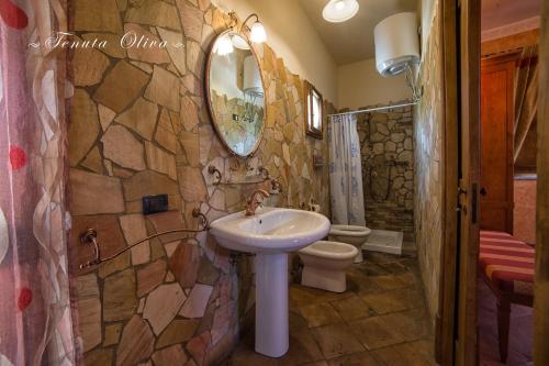 a bathroom with a sink and a toilet at Tenuta Oliva in Fisciano