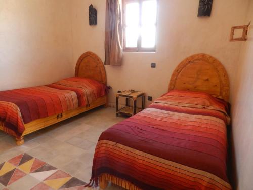 מיטה או מיטות בחדר ב-Borj Biramane