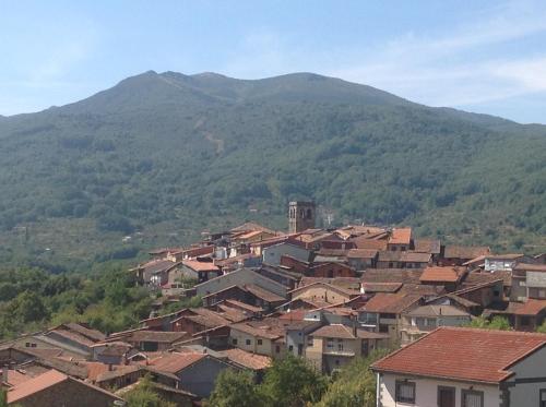 a group of houses in front of a mountain at Apartment Valle de Cepeda in Cepeda