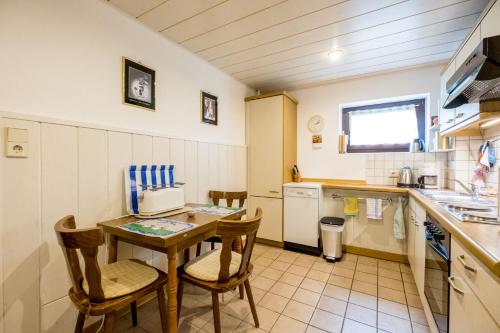 a kitchen with a table and chairs in a kitchen at Haus Fernblick in Bad Grund