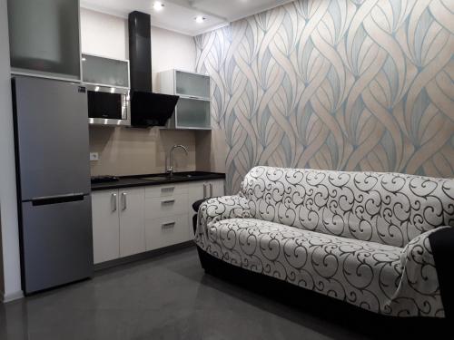 a living room with a couch in a kitchen at IRIS apartments in Odesa